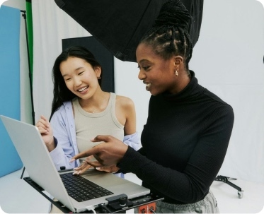 Two colleagues reviewing patient messages together on a laptop.